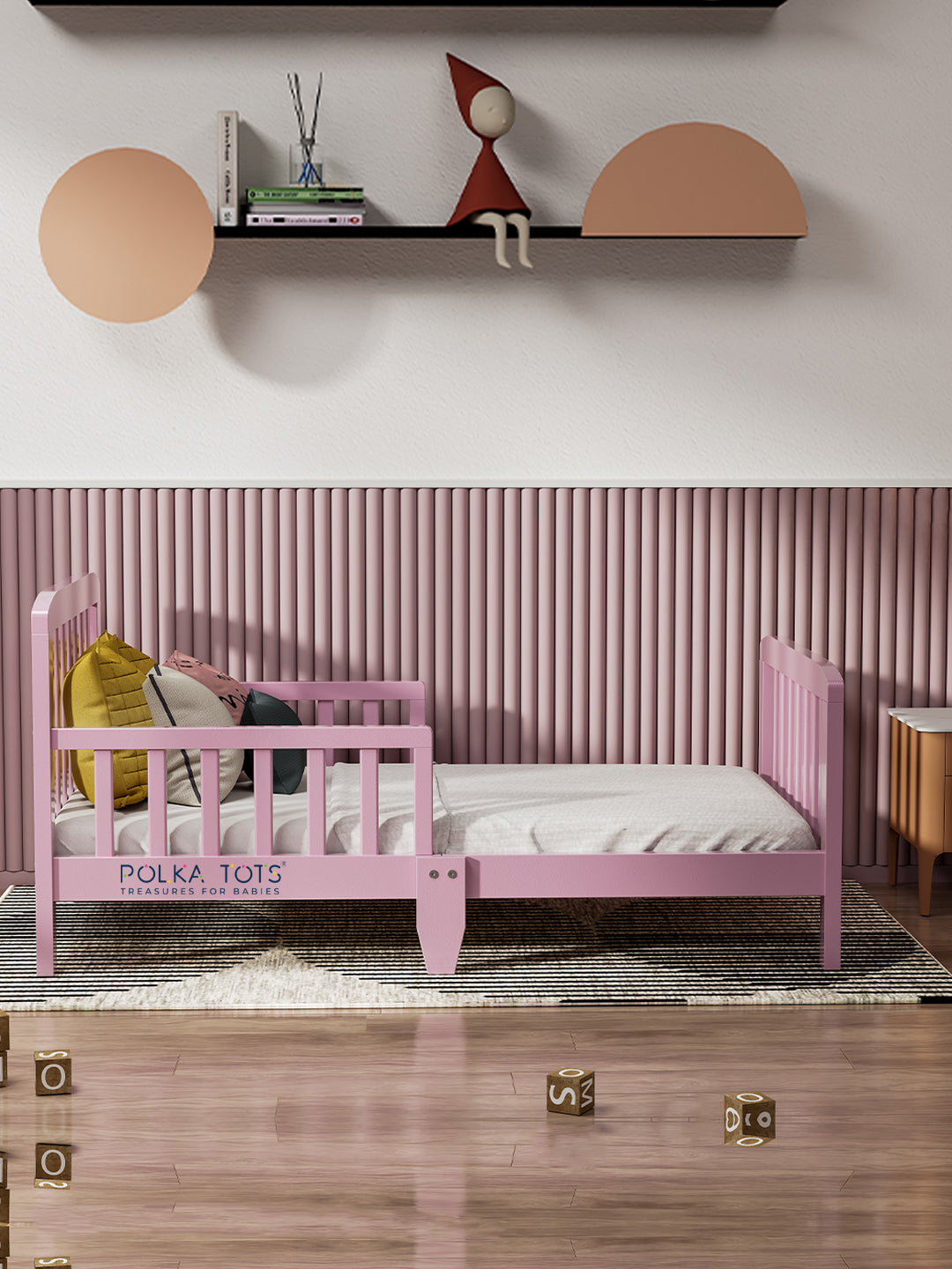 Pink children's bed in a room with a shelf and decorative items.