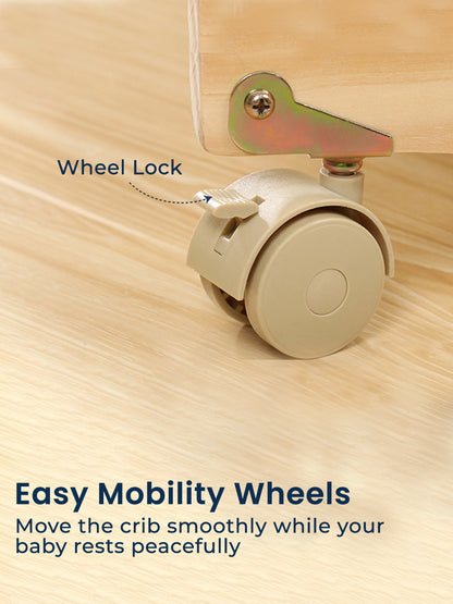 Beige crib wheel with a lock mechanism on a wooden surface, labeled 'Wheel Lock'.