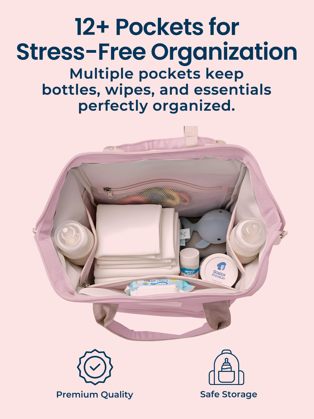 Pink diaper bag with multiple pockets containing bottles, wipes, and essentials on a white background.