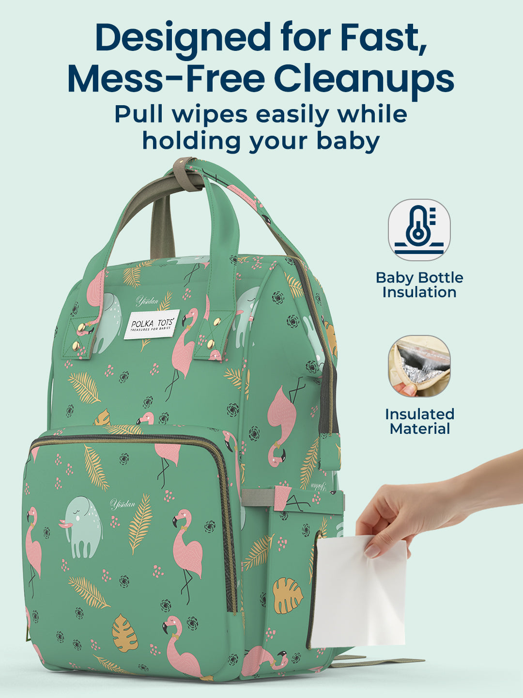Green diaper bag with flamingo pattern and pull-out wipes, on a light blue background.