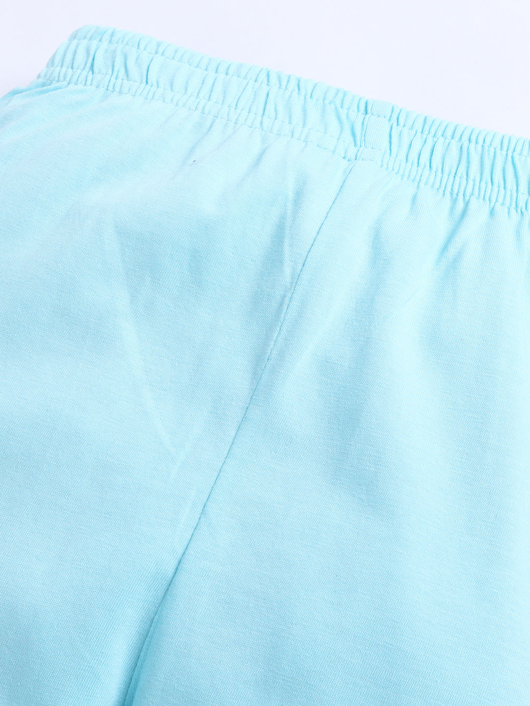 Close-up of light blue shorts with a plain background