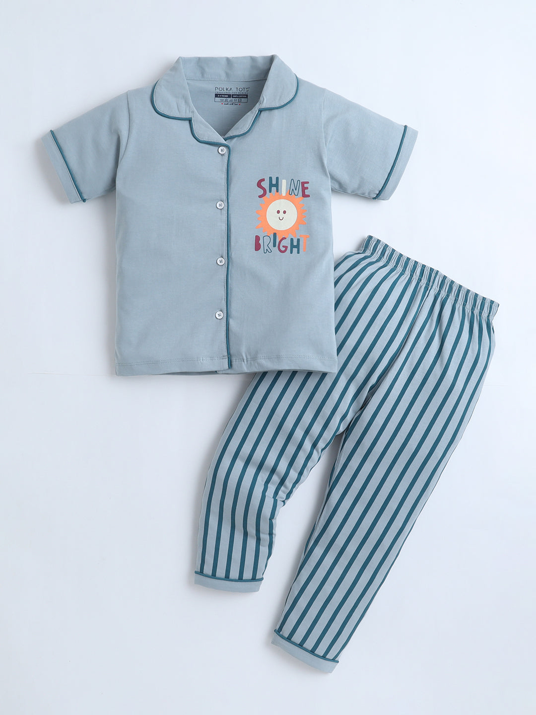 Children's pajama set with a shirt and striped pants on a light gray background