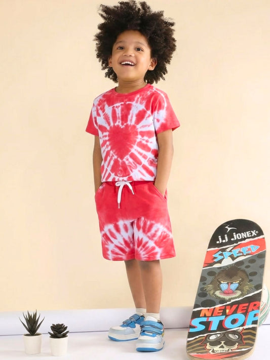 Child wearing a red and white tie-dye outfit with a skateboard on a beige background
