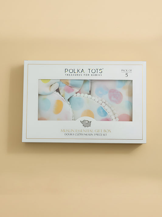 Polka Tots baby product packaging on a beige background