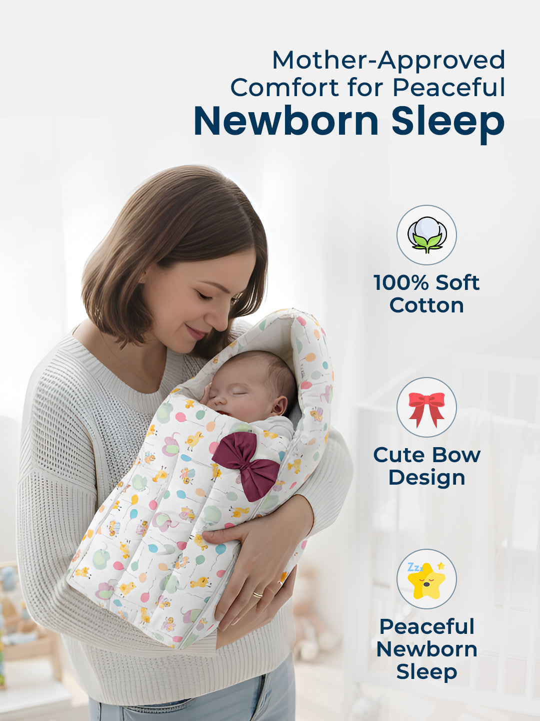 Woman holding a baby wrapped in a soft, colorful blanket with a bow design against a light background.