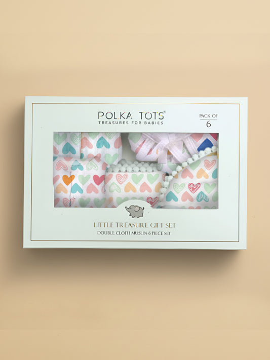 Polka Tots baby gift set packaging with heart-patterned cloth on a beige background