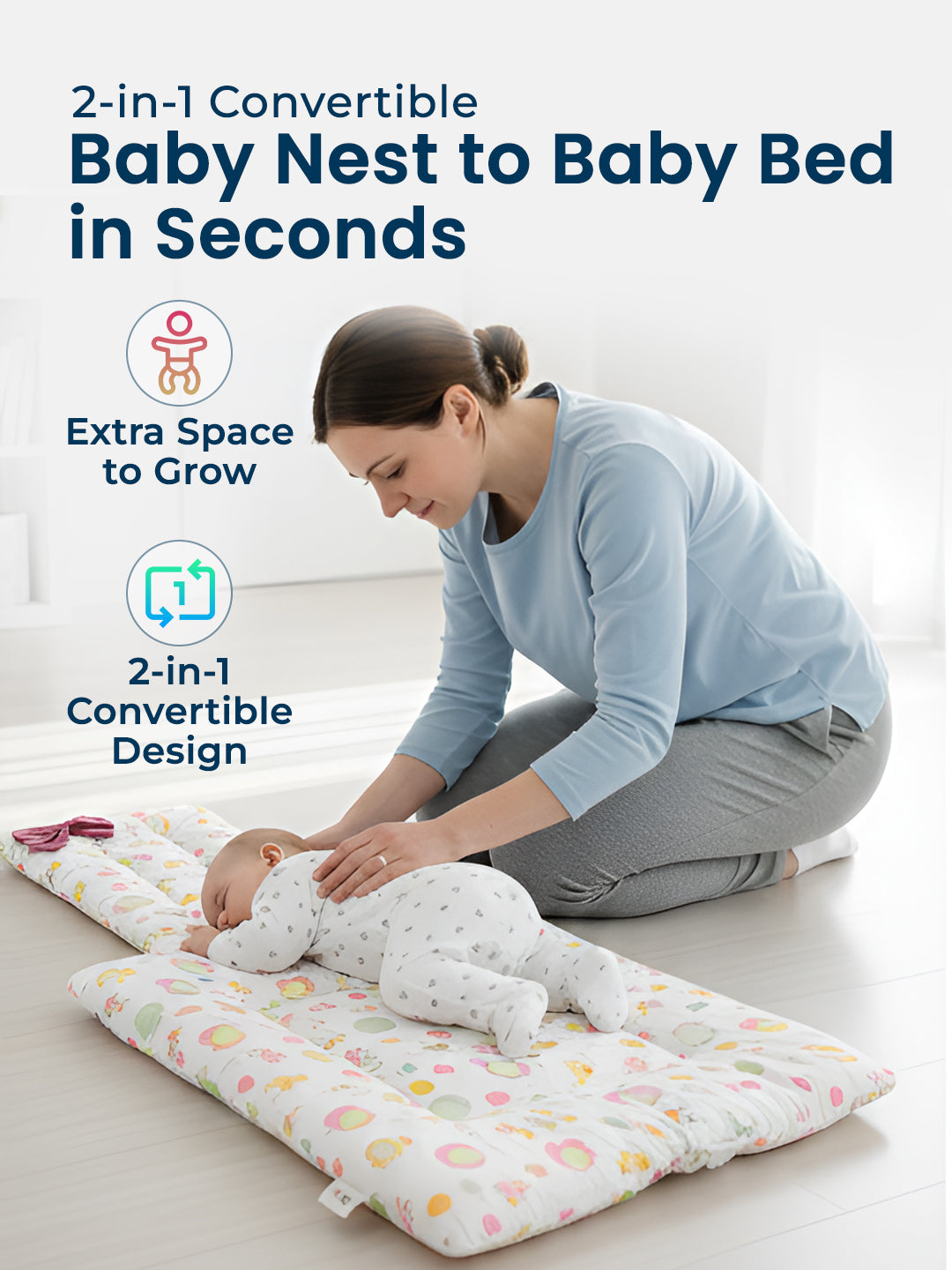 Woman with a baby on a 2-in-1 convertible baby nest and bed in a bright room.