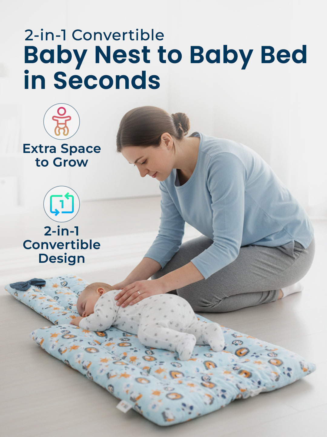 Woman with a baby on a 2-in-1 convertible baby nest and bed in a minimalistic room.